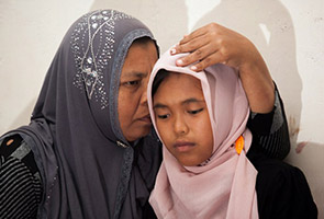 Indonesians hope to find son lost in tsunami after reunion with daughter