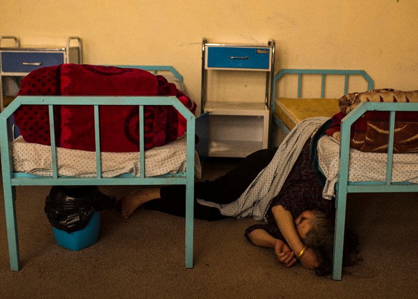 A drug-addicted woman who was admitted the day before sleeps on the floor where she fell in the detoxification ward last month at the National Center for the Treatment of Addiction for Women and Children in Kabul. The center, which opened several months ago, is one of the few such facilities for women in Afghanistan. (Andrew Quilty/For The Washington Post)