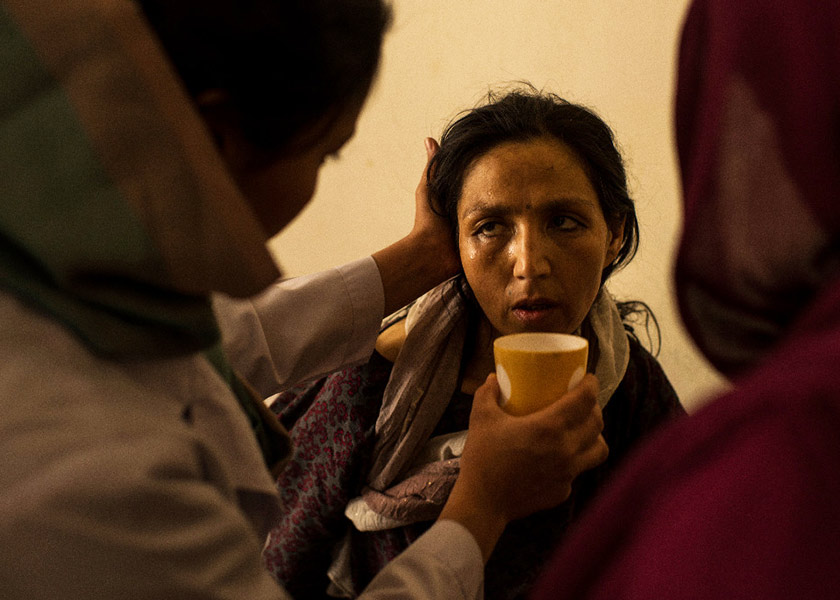   A woman recently admitted to the National Center for the Treatment of Addiction for Women and Children in Kabul is calmed by nurses and doctors after collapsing in a corridor during withdrawal from her opium addiction. She was brought to the facility by her 16-year-old daughter, who insisted she stay there until she recovered, saying, 