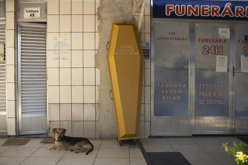 An empty coffin stands against the wall at the entrance of a funeral home during the COVID-19 pandemic at the Nossa Senhora das Gracas cemetery in Duque de Caxias, Rio de Janeiro, Brazil, Monday, April 27, 2020. Cases of the new coronavirus are overwhelming hospitals, morgues and cemeteries across Brazil as Latin America’s largest nation veers closer to becoming one of the world’s pandemic hot spots - AP Photo/Silvia Izquierdo