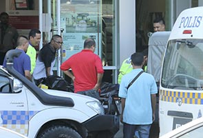 Guard runs amok, kills bank officer, injures another Guard runs amok, kills bank officer, injures another