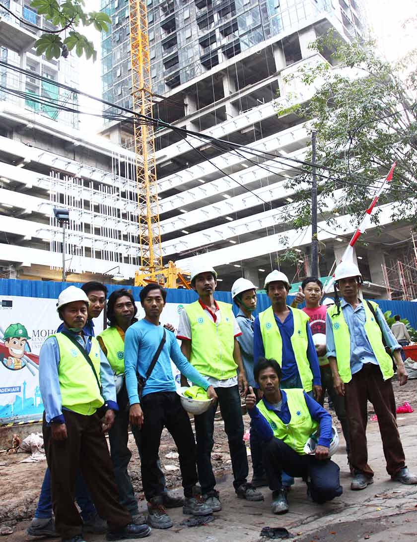 Pak Tukin and his friends before getting to work at the construction site. - Karim Raslan Photo