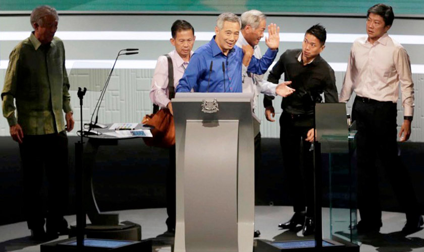 Singapore's Prime Minister Lee Hsien Loong is helped off the stage after taking ill during his National Day rally speech in Singapore August 21, 2016. Wee Teck Hian/TODAY/via REUTERS