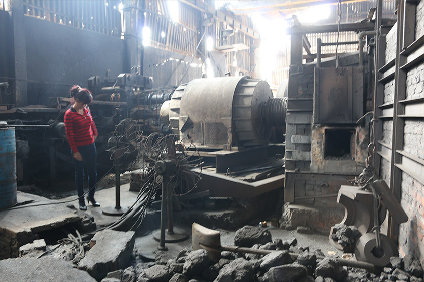 Trần Thị Lợi in her steel production facility which produces construction materials from iron ingots. The machine besides her costs USD350,000. Karim Raslan Photo