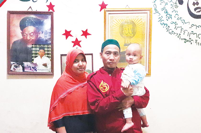 Ahmad Zakarsih with his family at their home in Bekasi. He and his wife had an arranged marriage and are now raising their two-year- old son. - Karim Raslan Photo