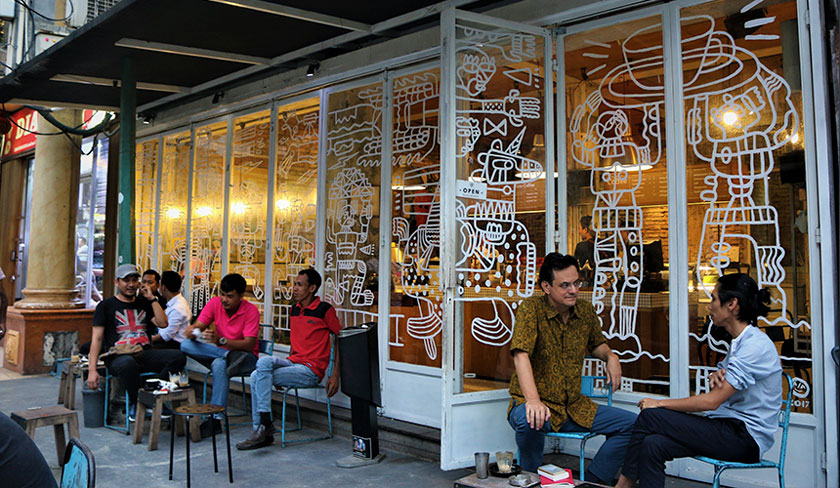 Karim Raslan and Angga Sasongko relaxing and sipping coffee at the Filosofi Kopi shop in Melawai, Jakarta. Karim Raslan Photo