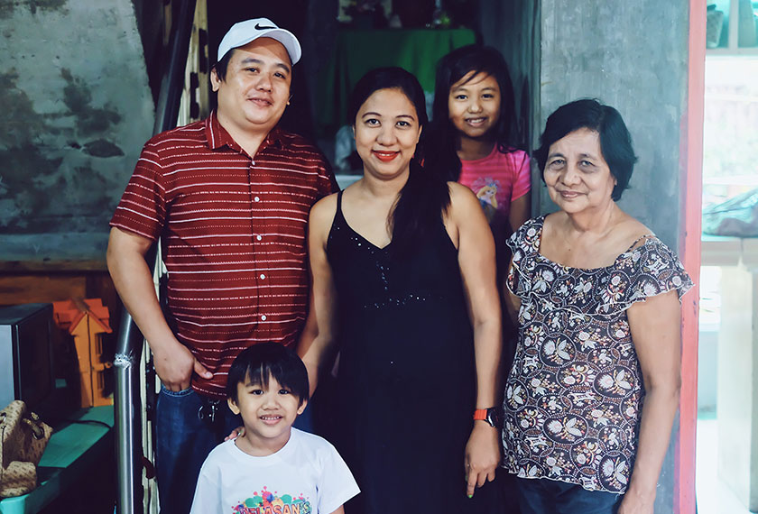 Joy and her family at their home. Ceritalah / Chao Wee Lee