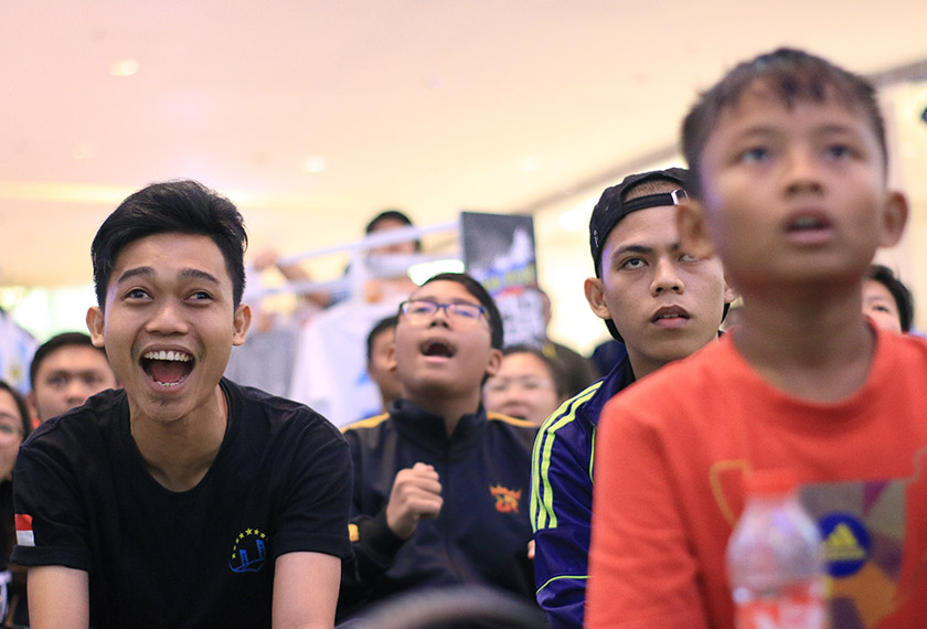 Riko (left), a security guard at a department store, cheers for Mexico during a live stream in Jakarta’s Kuningan district. Mexico lost their match against Brazil 0-2 on 2 July 2018.