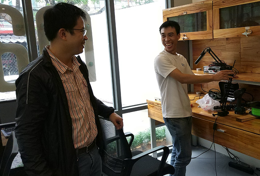 Hoi (left) shares a light moment with a colleague at Maker Space. Mai Duong / Ceritalah