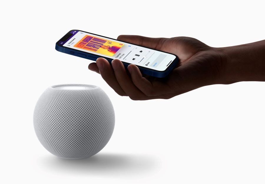 Apple's HomePod mini is seen with an iPhone in a photograph released in Cupertino, California, U.S. October 13, 2020. Apple Inc./Handout via REUTERS