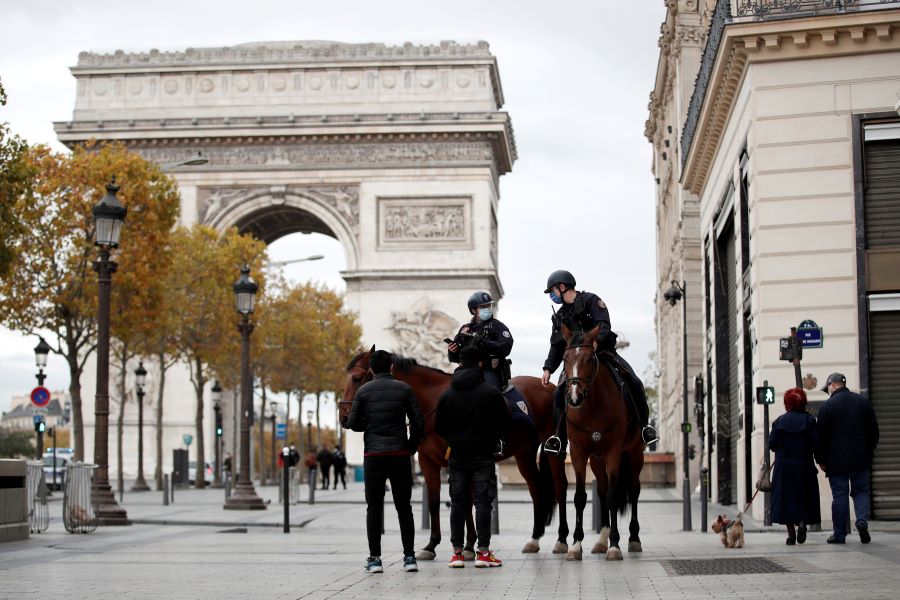Police officers on horses conduct a control to check exemption certificates and verify the identity on the Champs-Elysee avenue as France re-imposed a monthlong nationwide lockdown aimed at slowing the spread of the coronavirus (COVID-19), in Paris October 31, 2020. REUTERS/Benoit Tessier