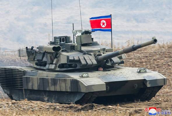 North Korea's Kim 'drives' new tank during mock battle