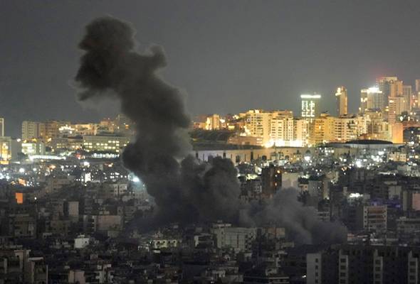 Lebanese flee as blasts hit Beirut, Israel warns of strikes on Hezbollah finance arm