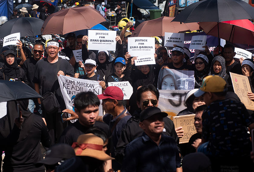 Peserta hadir berpakaian serba hitam sambil membawa plakad tertera nama Zara, "Justice for Zara Qairina" dan "Stop Bullying". - Foto Bernama