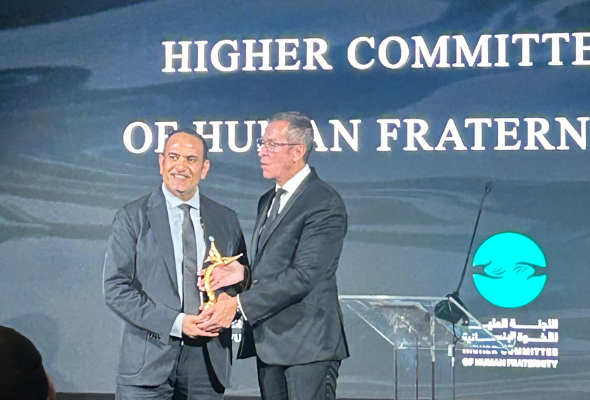 A man accepting award at a gala dinner