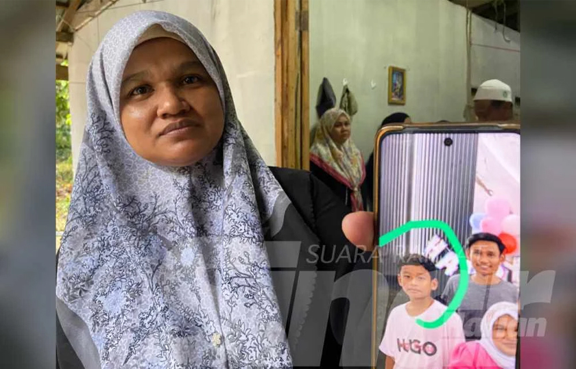 Norzaizura menunjukkan gambar Mohamad Syafi Irsyad semasa ditemui di rumahnya di Kampung Banggol Judah, Machang pada Sabtu.  - Foto Sinar Harian
