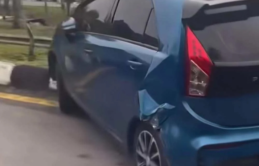 Proton Iriz mengalami kerosakan luaran selepas dihimpit treler dalam kejadian di R&R Jejantas Ayer Keroh, Melaka. - Foto Sinar Harian